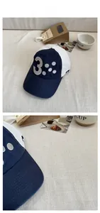 Detail shot of navy and white color-block baseball cap with grey number 3 embroidery