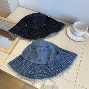 Retro denim bucket hats with frayed edges and metallic rivets in blue and grey