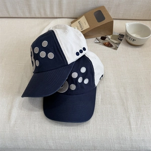 Retro two-tone navy and white canvas baseball cap with embroidered letter B and dots
