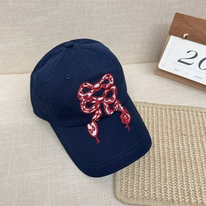 Navy cotton baseball cap with red snakeskin bow embroidery for a chic streetwear look