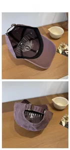 Detail view of purple vintage washed baseball cap with adjustable brass buckle and inner lining