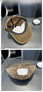 Detail of leopard print baseball cap featuring interior structure and metal adjustment buckle