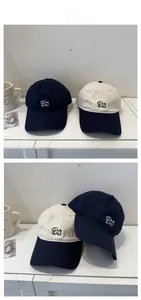 Detailed embroidery of a minimalist puppy design on washed cotton baseball caps