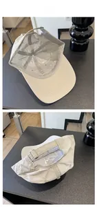 Detail of adjustable silver buckle and internal structure on beige quick-dry baseball cap