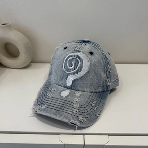 Vintage light blue washed denim baseball cap with distressed details and spiral embroidery