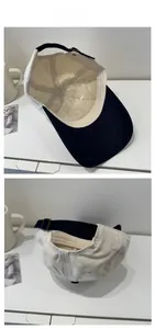 Detailed back view of a beige cotton baseball cap with navy brim and metal buckle strap