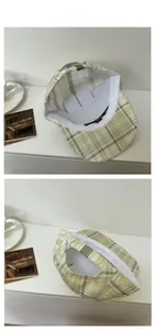 Detail of plaid baseball cap showing metal buckle adjustment and inner structure
