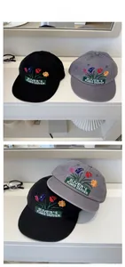 Close-up of flower embroidery and Oliver's Flower Garden patch on baseball caps