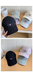 Close-up of cute panda embroidery and lettering on cotton baseball caps in various colors