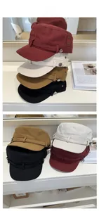 Detail shot of vintage washed canvas military caps in various colors with metal buckle