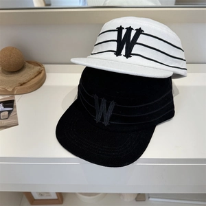 Corduroy flat brim baseball cap with gothic W embroidery in black and off-white colors