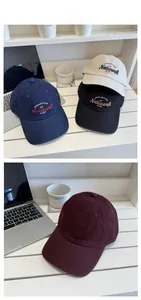 Close-up of premium corduroy baseball caps with detailed Network embroidery texture