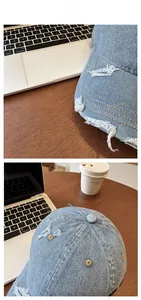 Close-up of light blue washed denim baseball cap featuring vintage distressed frayed details