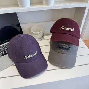 Three corduroy baseball caps in purple, burgundy and grey with Network embroidery