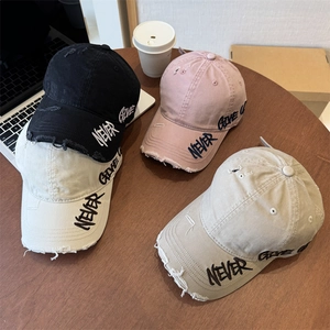 Distressed cotton baseball caps in four colors featuring Never Give Up embroidery