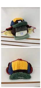 Detail of colorful patchwork fleece aviator hat with frog eye decor and ear flaps