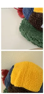 Detail view of multi-color patchwork fleece hat with ear flaps and decorative red strings