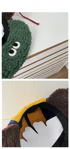 Detail view of colorful patchwork fleece pilot hat with cute cartoon eyes and soft lining