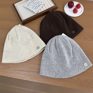 Winter knit beanies in beige, dark coffee, and grey with minimalist metal logo labels