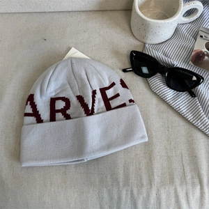 Light gray knit beanie with burgundy HARVEST lettering and rolled cuff for winter warmth