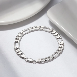 Macro shot of S925 sterling silver Figaro chain bracelet with ITALY hallmark engraving