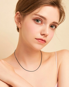 Close-up of a 3.0mm black leather necklace cord with a 925 silver clasp on a model