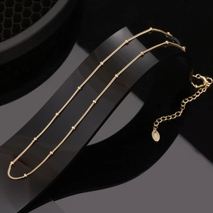 Macro shot of 14K gold-plated S925 sterling silver beaded chain with adjustable clasp