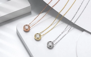 Three-color silver bubble pendants in gold, rose gold and silver on geometric stones