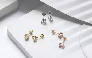 Detailed view of oval zircon stud earrings in silver gold and rose gold finishes
