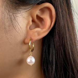 Close-up of S925 sterling silver gold plated earring with a lustrous baroque pearl on ear