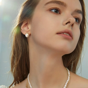 925 sterling silver earrings and baroque pearl necklace set worn by model in gold finish