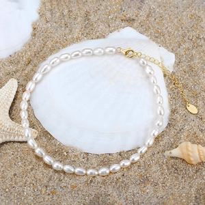 S925 sterling silver anklet featuring 3.5mm natural pearls on a white shell and sand base