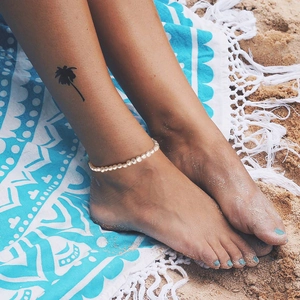 Minimalist S925 sterling silver anklet with 3-4mm Baroque pearls on a sandy beach