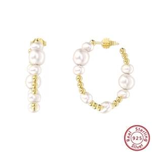 Detailed close-up of 925 sterling silver hoop earrings with Baroque pearls and gold finish