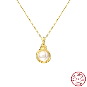 Detailed macro view of 925 sterling silver chain with a wrapped pearl pendant