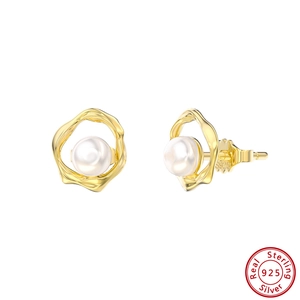 Detail of 925 sterling silver stamp and freshwater pearl on golden lava style earring