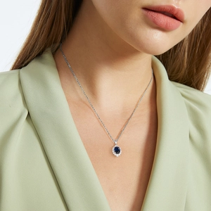 S925 sterling silver necklace featuring an oval blue sapphire pendant with diamond halo