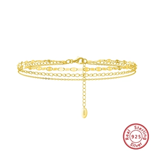 Macro detail of multi-layer S925 sterling silver gold-plated anklet with lobster clasp