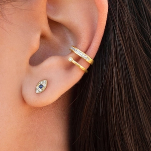 Golden Evil Eye stud and double-layered pavé ear cuff set worn by a female model