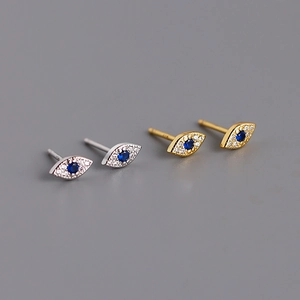 Detailed macro view of S925 silver devil eye stud earrings in gold and silver plating