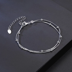 Detailed macro of S925 sterling silver double-layer bead chain with lobster clasp and tag