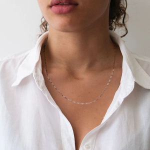 Detail of s925 sterling silver paperclip link chain necklace worn on neck