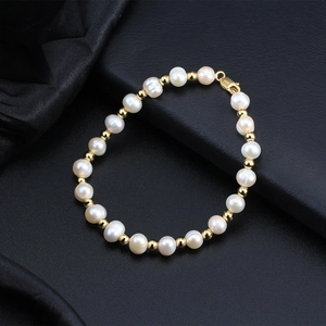 Elegant adjustable freshwater pearl and gold bead bracelet with lobster clasp on black background