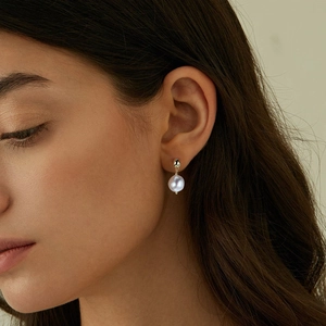 Elegant 925 sterling silver freshwater pearl earrings worn by a model for a luxury look