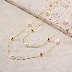 Elegante collana a doppia catena dorata con perle naturali d'acqua dolce e grani d'oro