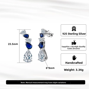 Macro detail of S925 sterling silver pear drop earrings with blue sapphire and 8A zircon