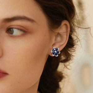 Elegant S925 sterling silver flower earrings with blue sapphire petals and zircon accents
