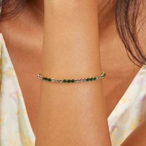 Macro shot of 925 sterling silver tennis bracelet with green and white cubic zirconia