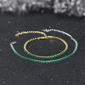 Detail of 3mm cubic zirconia tennis bracelets in gold and silver with green gemstones