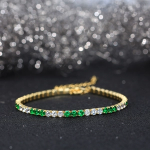 Detailed close-up of a 925 sterling silver tennis bracelet with green and white cubic zirconia